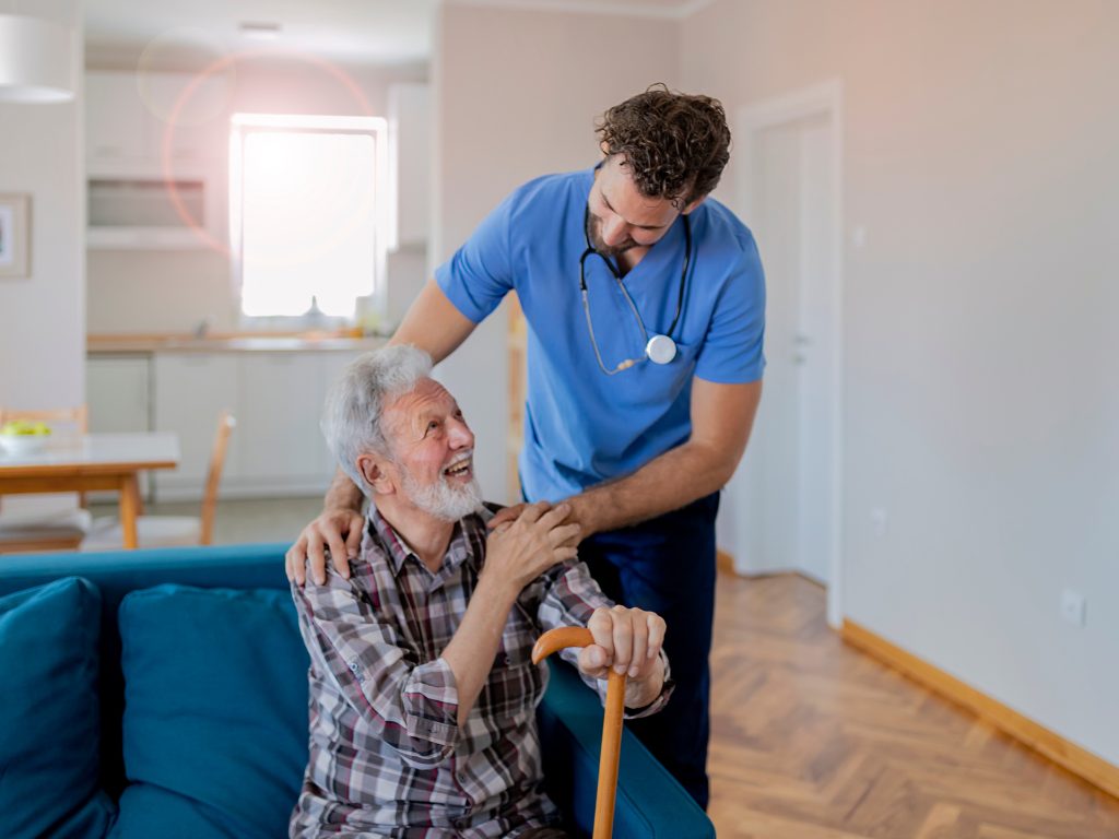 Caregiver assisting a client with a cane