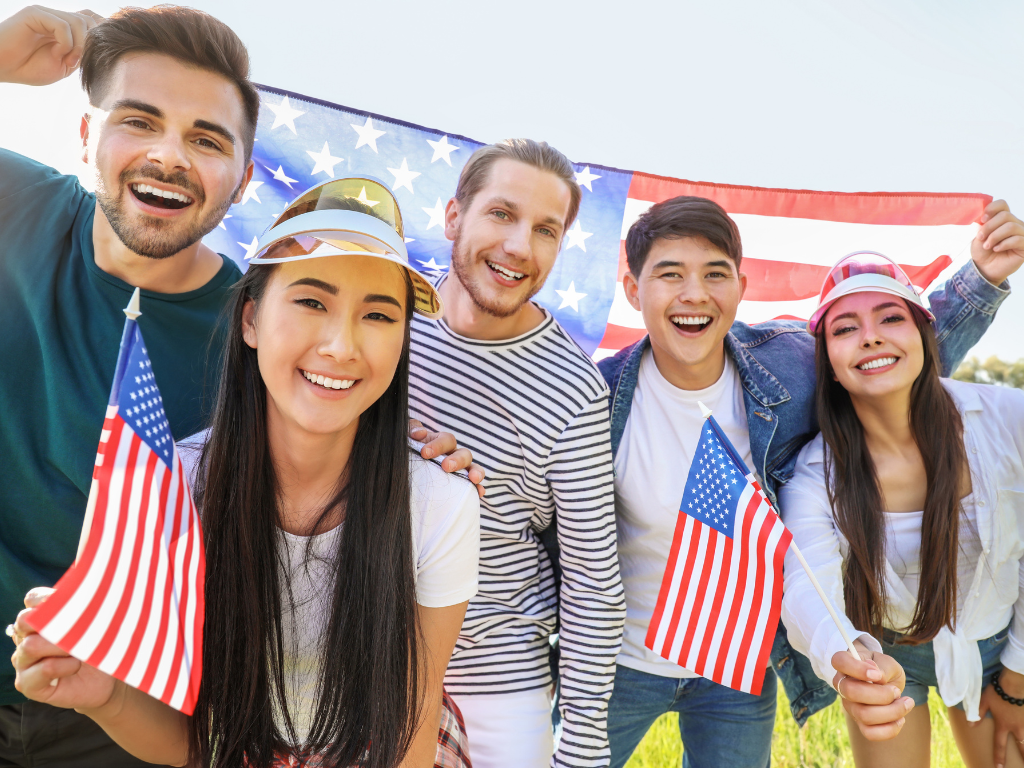 Crowd of people waving American flags