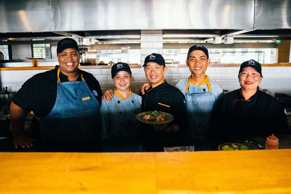 Restaurant kitchen team standing together