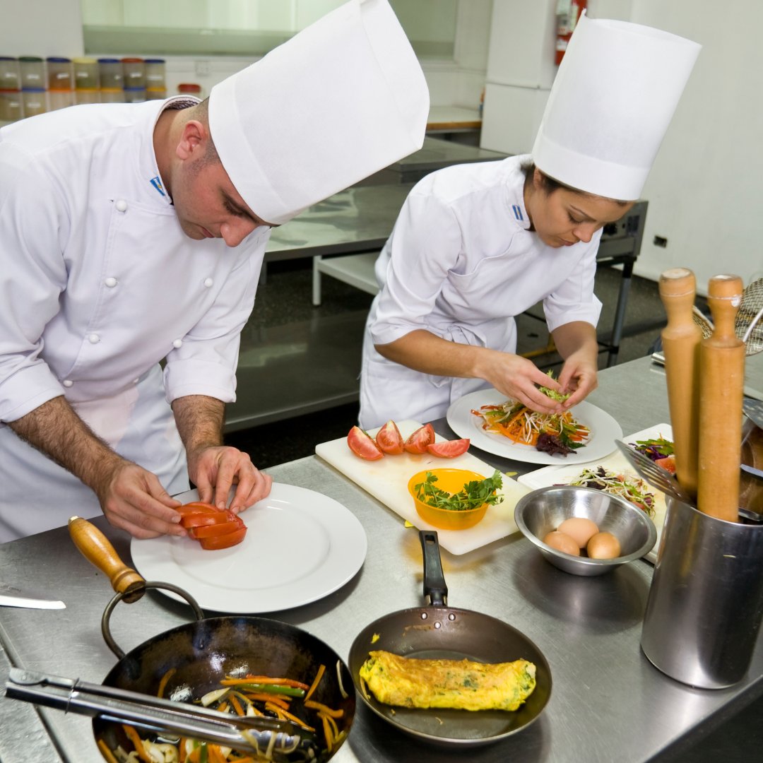 Kitchen staff plating food together