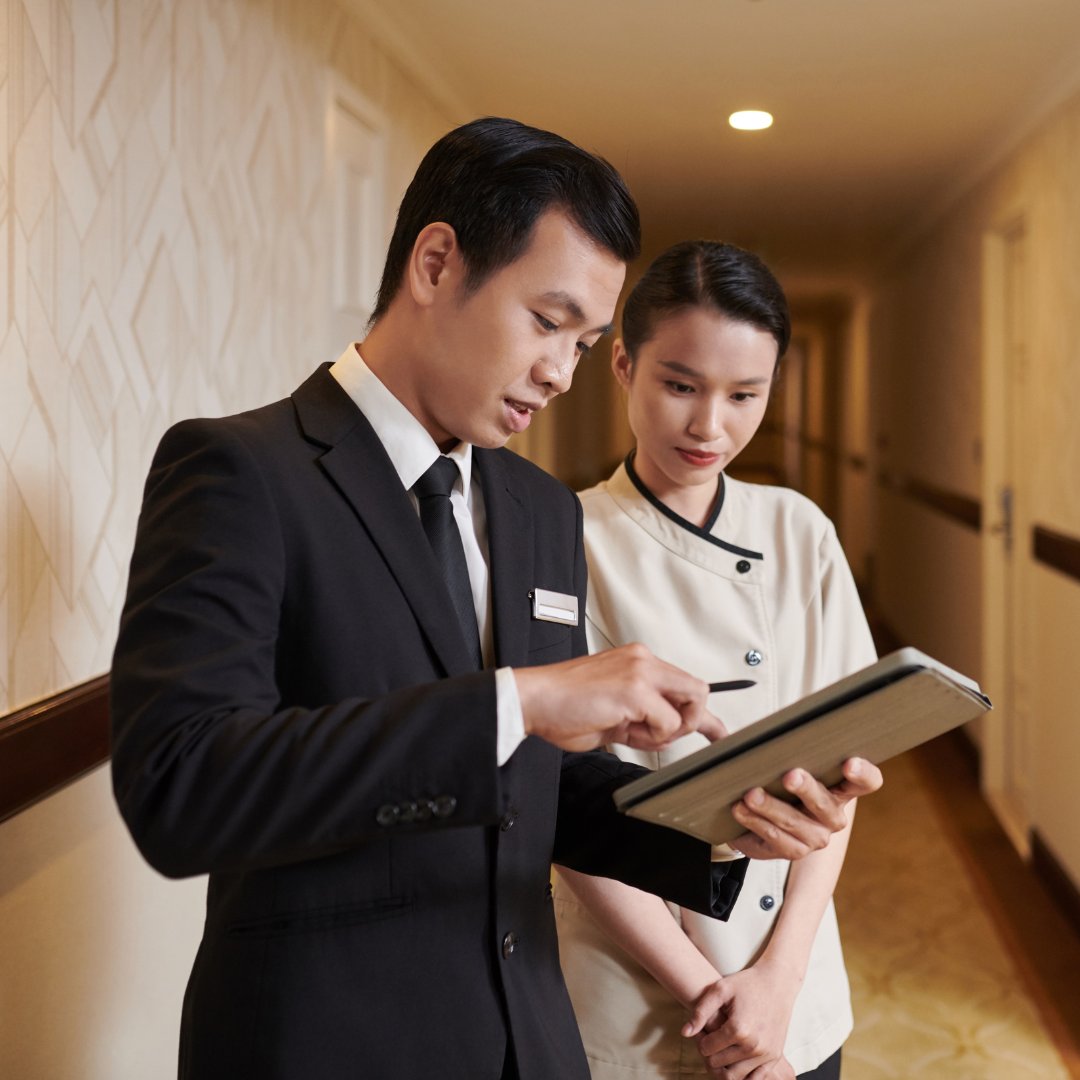 Hotel manager reviewing a schedule with a team member