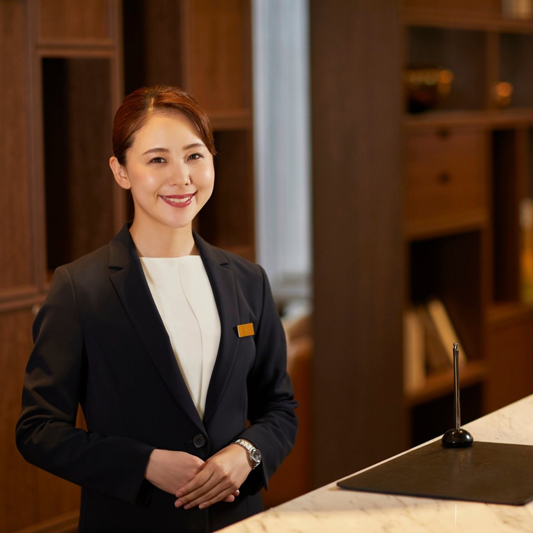 Hotel front desk agent greeting guests