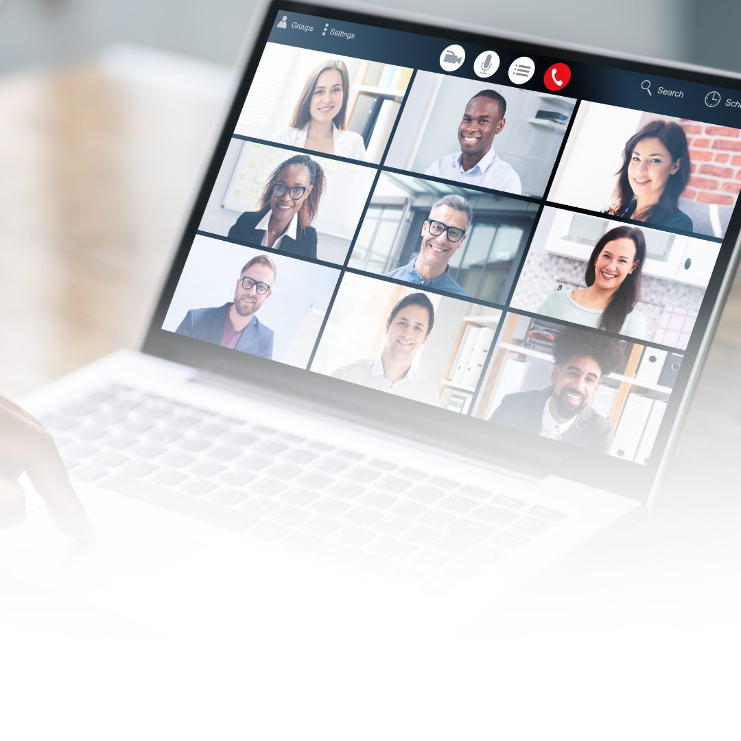 Laptop screen showing a remote team video call grid