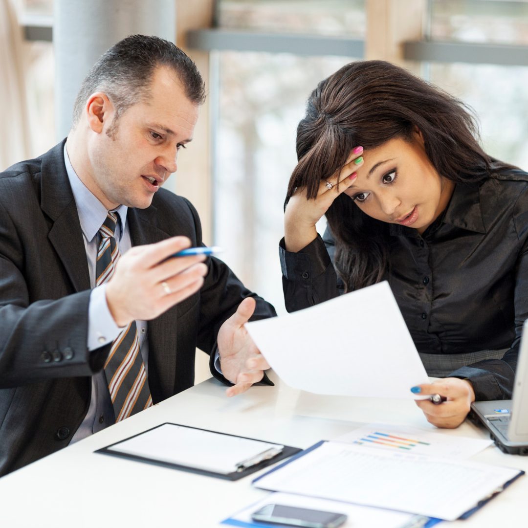 Managers reviewing staffing turnover reports